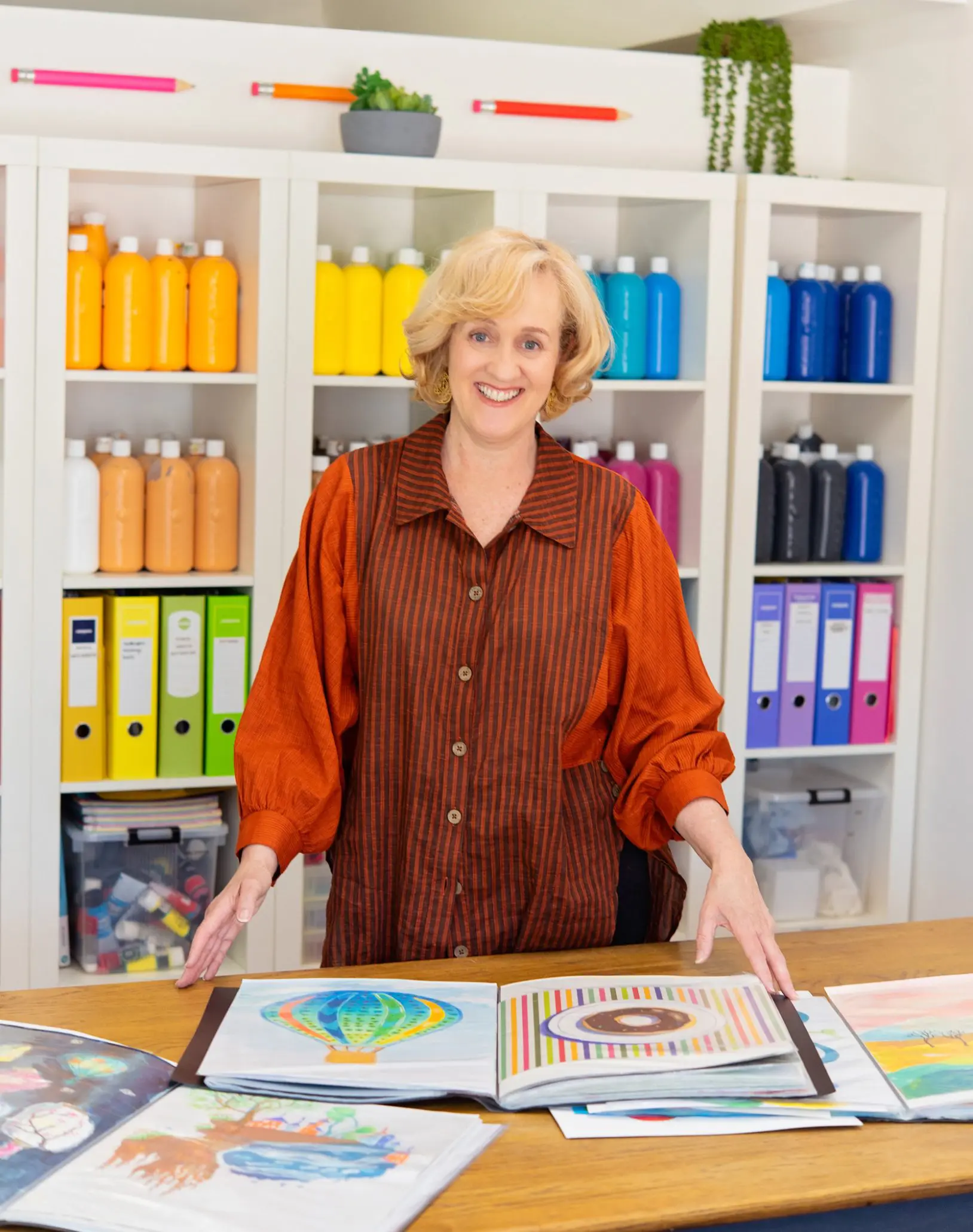 Jane McKay Smiling Over Art - About Us Banner