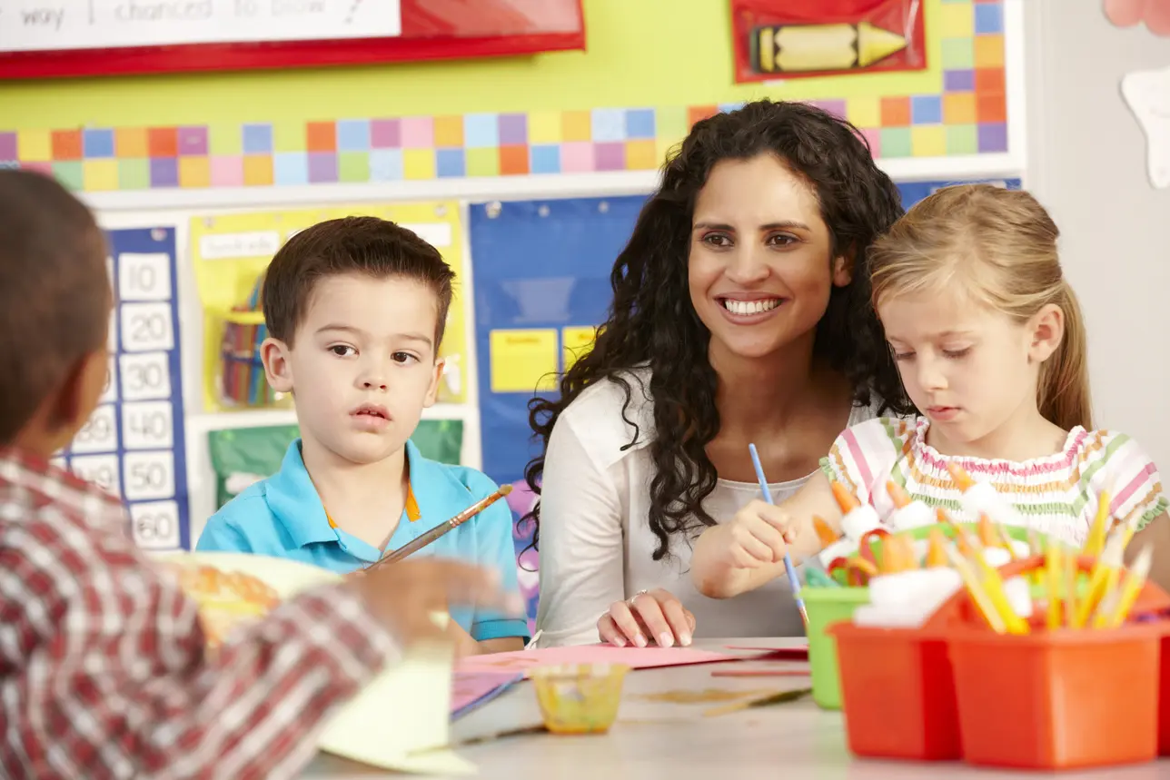 Group Of Elementary Age Schoolchildren in Art Class with Art Teacher